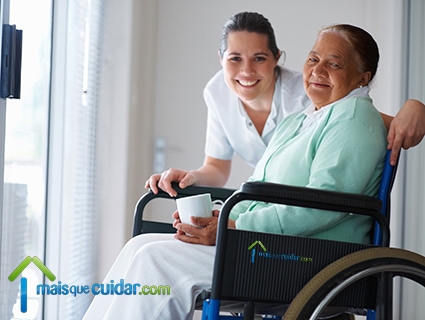 Image of elderly lady in wheelchair and carer 