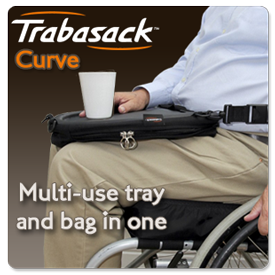 a man in a manual wheelchair has a cup on a trabasak laptray and wheelchair bag on his lap